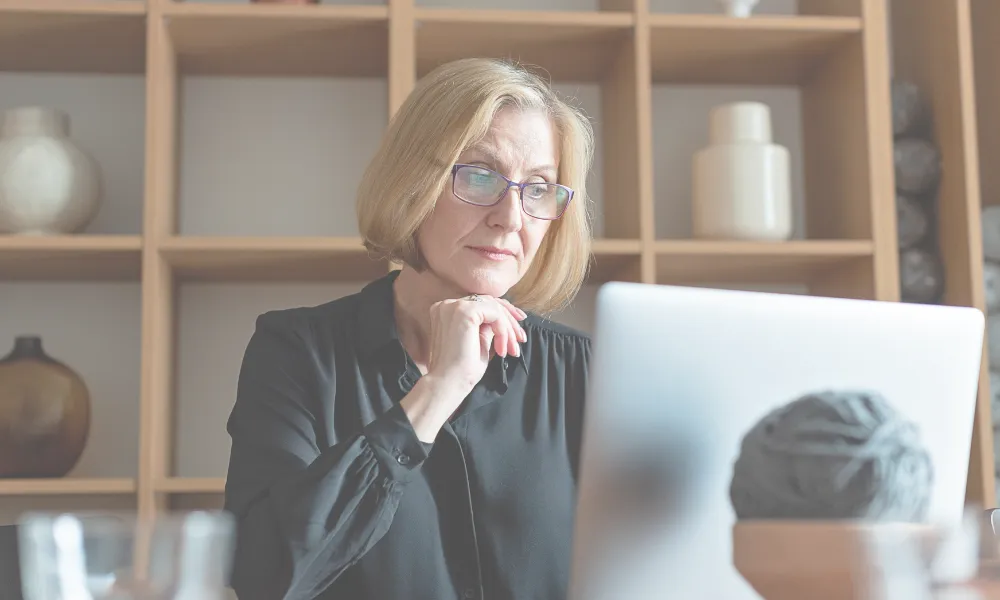 Experienced job seeker sitting at a computer.
