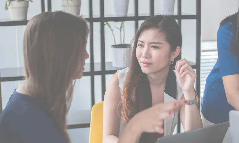 Two women talking to each other.